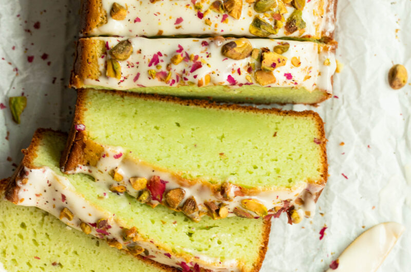 Sliced gluten-free pistachio pudding loaf with cream cheese frosting