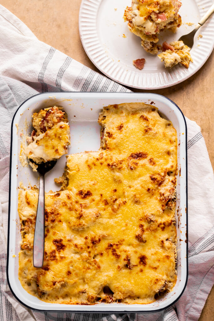 A wide shot of the whole baking dish with the breakfast bake after a few slices have been served.