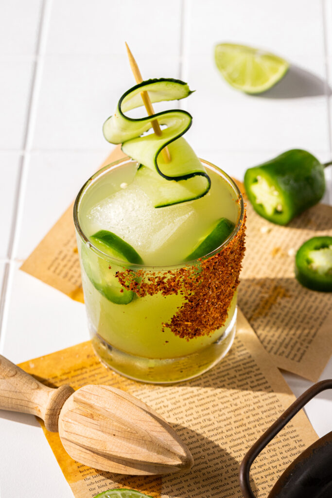 A photo emphasizing the cucumber ribbon garnish on top of the margarita.