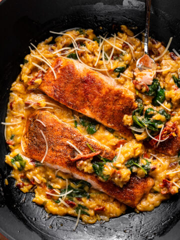 overhead shot of salmon fillets and orzo in a pot