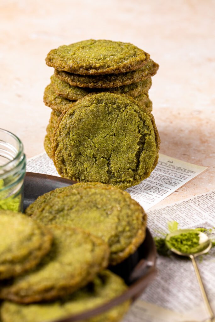 A stack of matcha cookies sitting on a table.